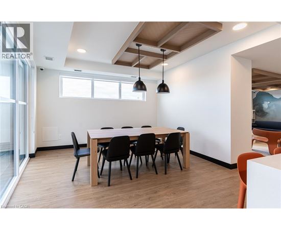 A conference room with a long table and chairs.