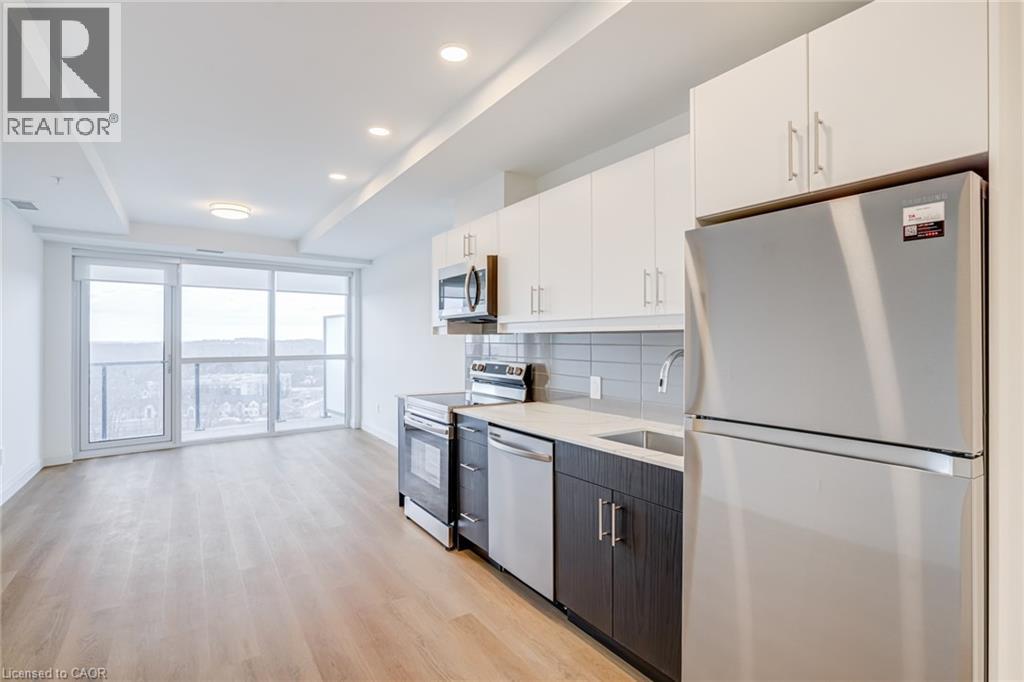 A modern kitchen with white appliances and wooden cabinets.