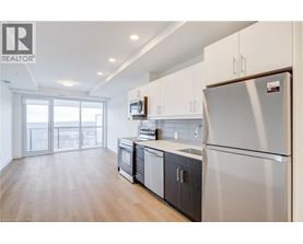 A modern kitchen with white appliances and wooden cabinets.