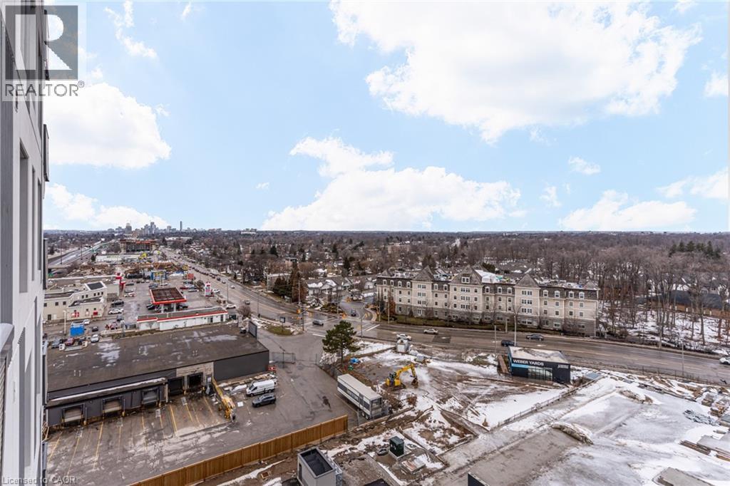 A view from a high vantage point looking down at a parking lot and buildings.