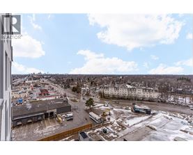 A view from a high vantage point looking down at a parking lot and buildings.