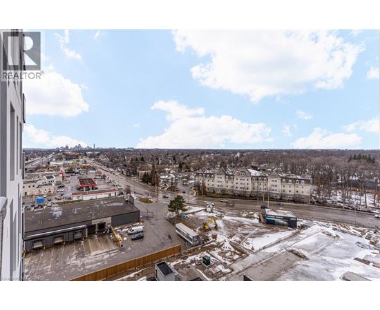 A view from a high vantage point looking down at a parking lot and buildings.