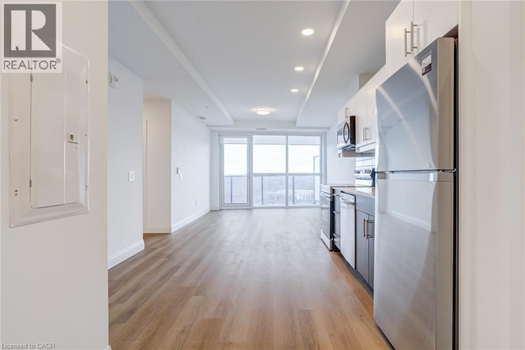 A modern kitchen with a refrigerator on the right side.