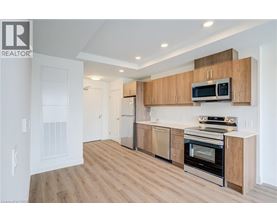 A modern kitchen with wooden cabinets and stainless steel appliances.