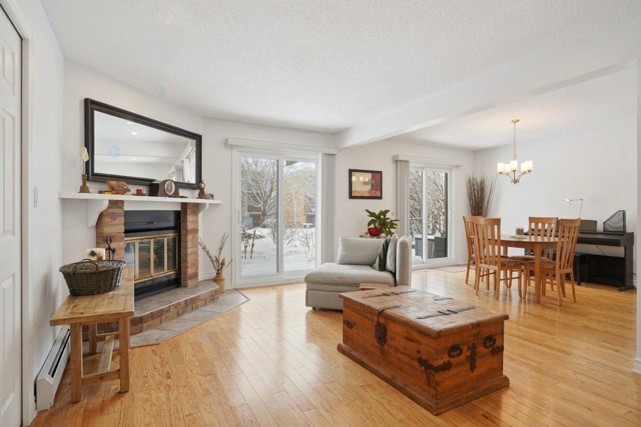 A living room with a fireplace and a wooden coffee table.