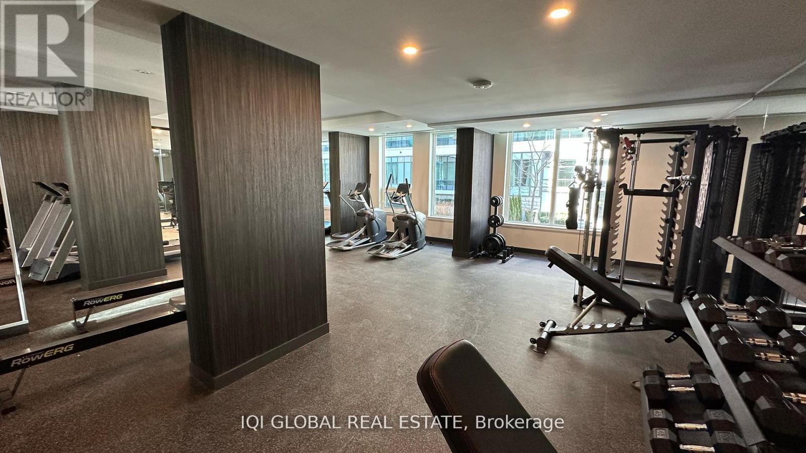 A gym with a variety of equipment including weights and machines.