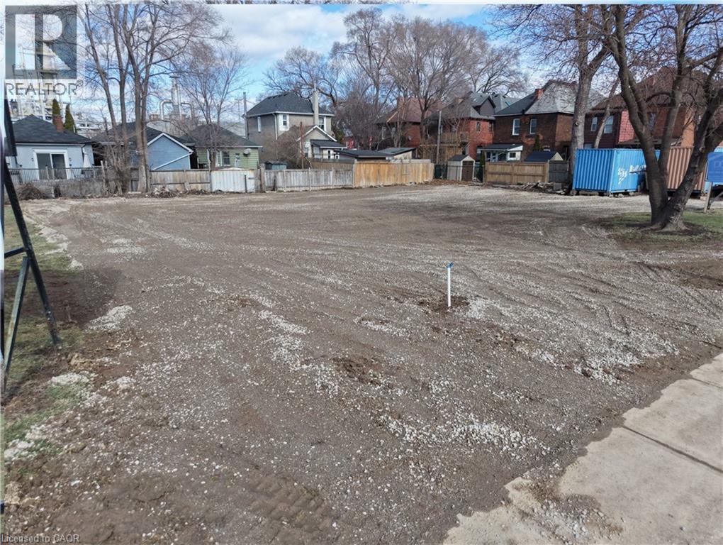 A dirt field with a white pole in the middle.