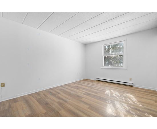 A room with a window and a radiator on the wall.
