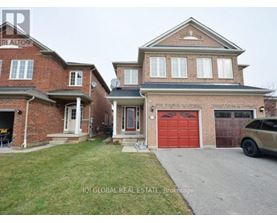 A house with a red garage door is for sale.