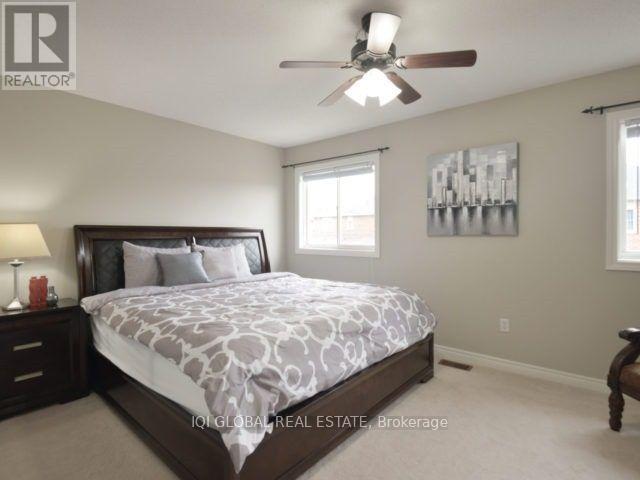 A bedroom with a large bed and a ceiling fan.