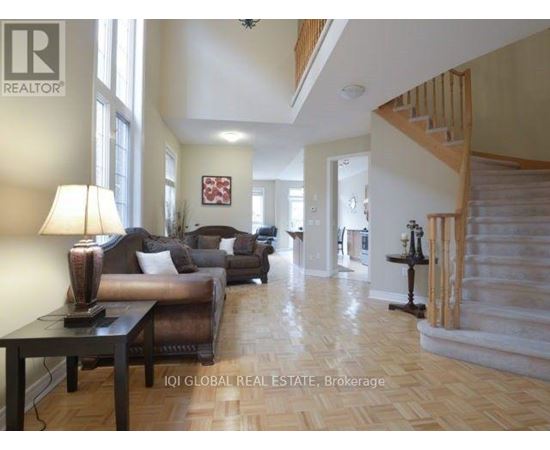 A living room with a brown couch and a wooden table.