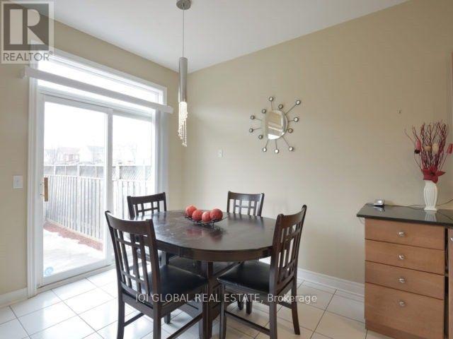 A dining room with a table set for two and a chandelier hanging from the ceiling.