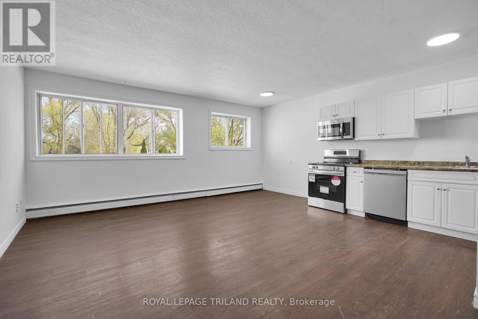 A kitchen with white cabinets and a stainless steel dishwasher.