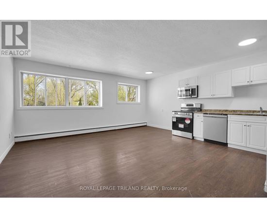 A kitchen with white cabinets and a stainless steel dishwasher.