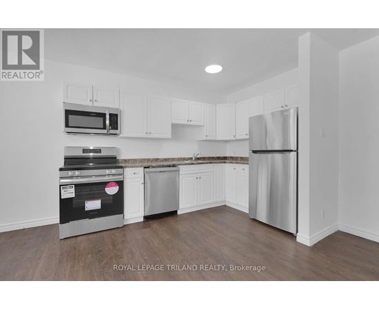 A kitchen with white cabinets and stainless steel appliances.