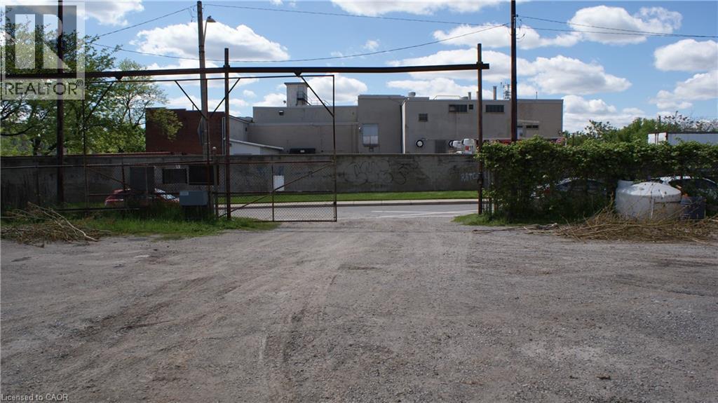 A gravel lot with a sign that says REALTOR.