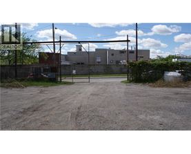 A gravel lot with a sign that says REALTOR.