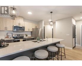 A modern kitchen with a large island and bar stools.