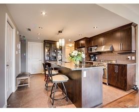 A kitchen with brown cabinets and a large island.