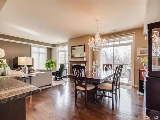 A dining room with a wooden table and chairs.