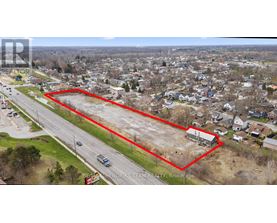 An aerial view of a residential area with a red outlined property for sale.