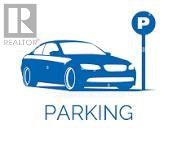 A blue car is parked next to a parking sign.