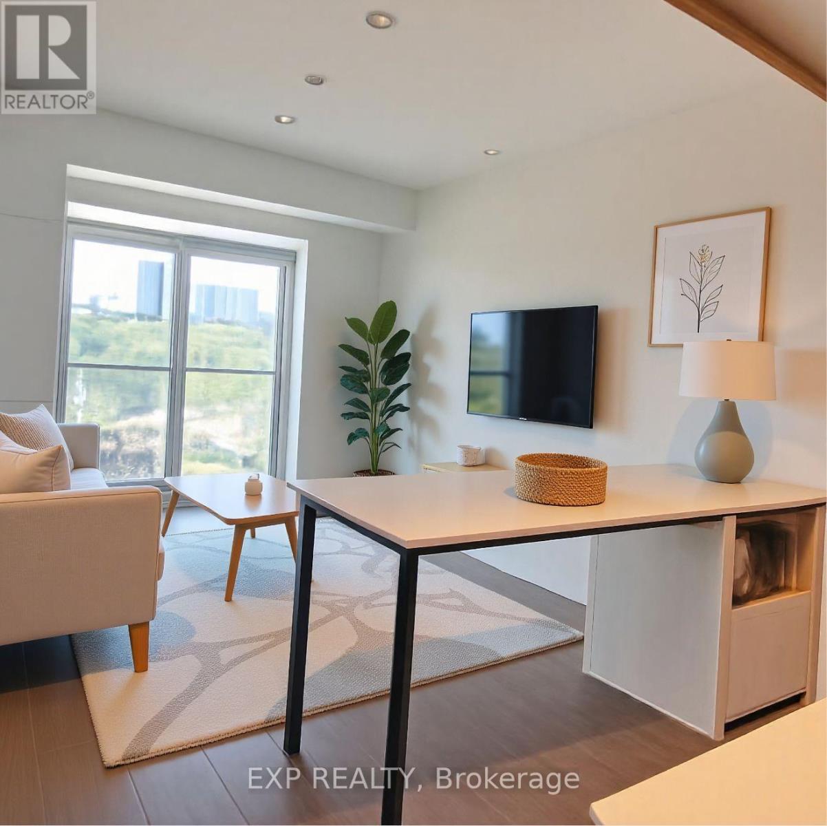A living room with a flat screen TV mounted on the wall.