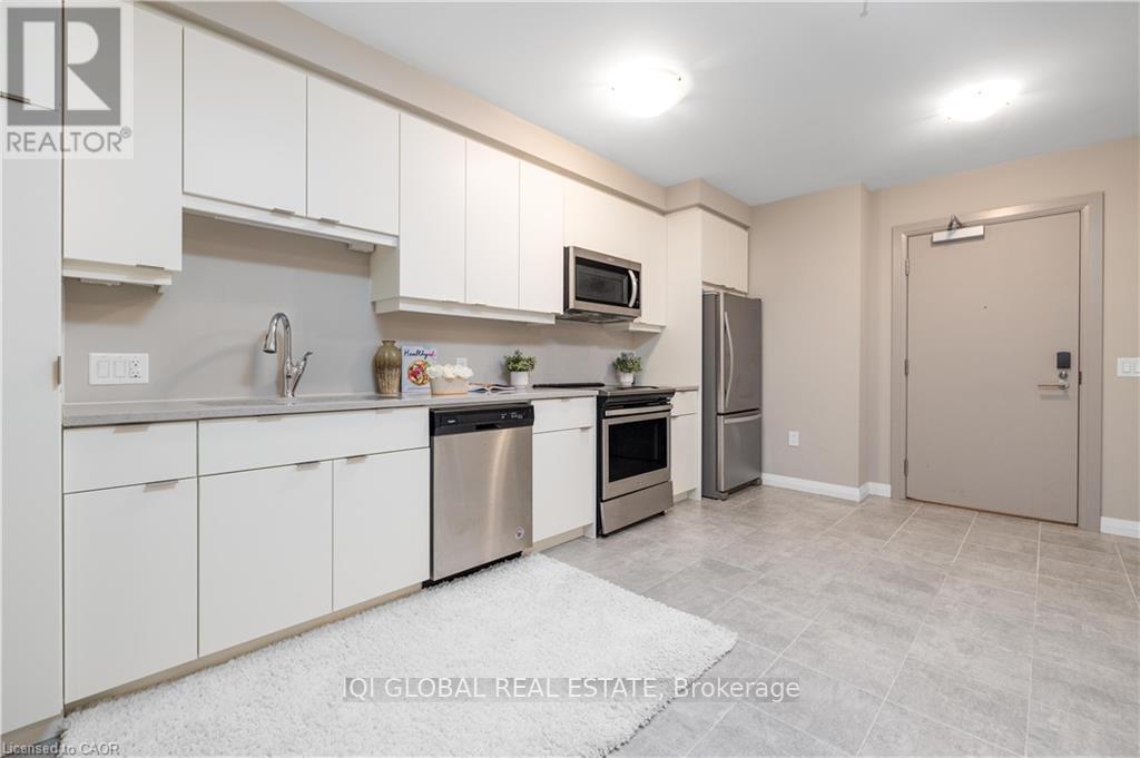 A kitchen with white cabinets and stainless steel appliances.