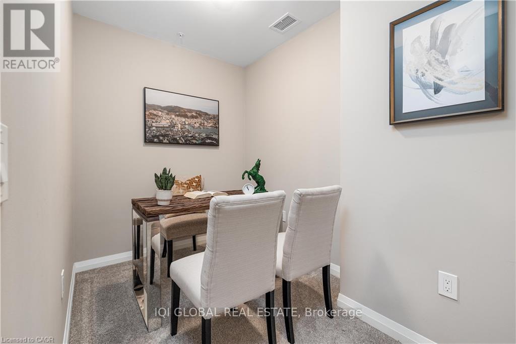 A dining room with a table and chairs.