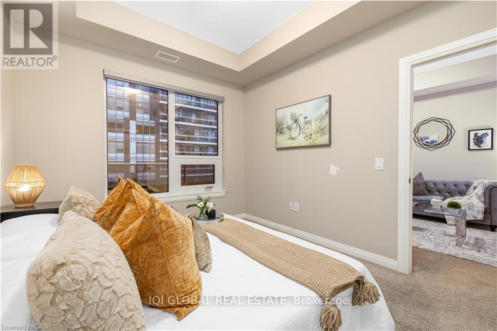 A bedroom with a large bed and a window with blinds.