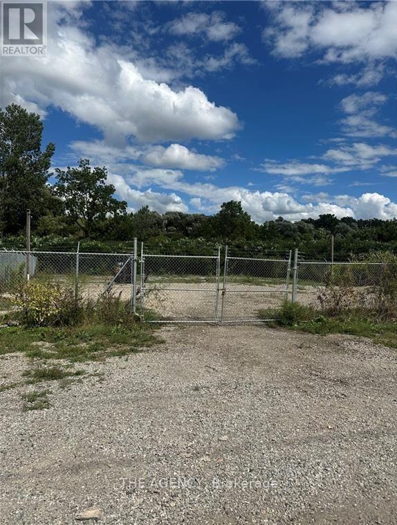 A gate blocks the way to a dirt road.