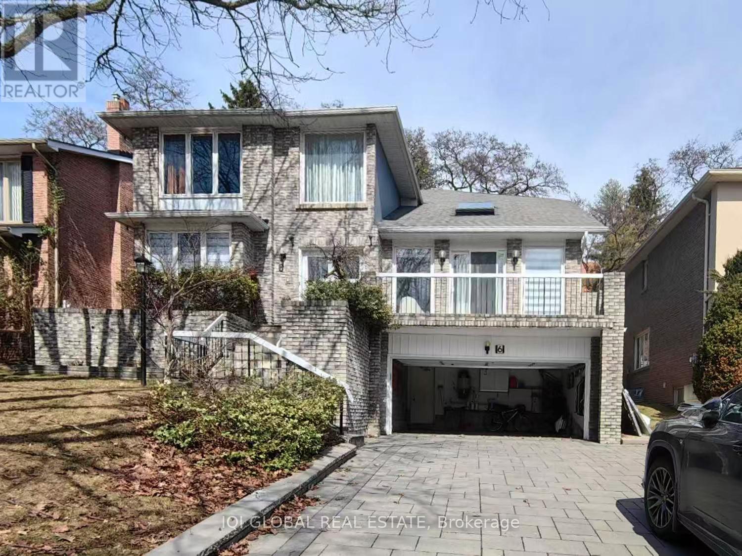 A house with a garage and a car parked in front.