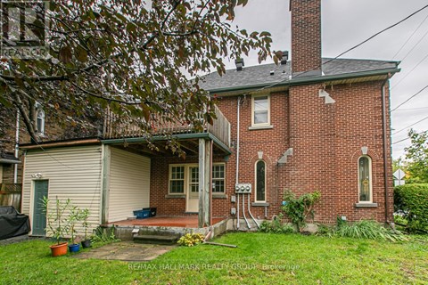 A red brick house with a white garage door and a green door.