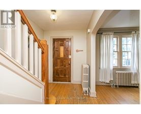 A room with a wooden door and a radiator.