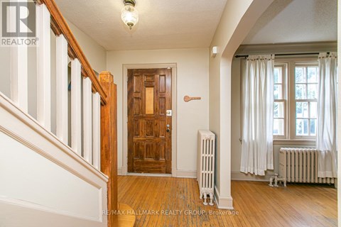 A room with a wooden door and a radiator.