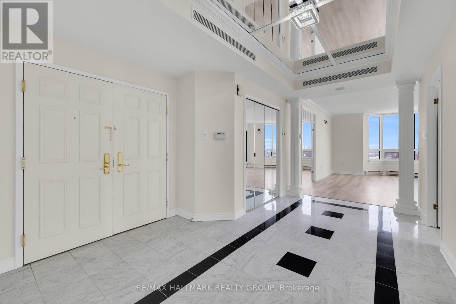 A spacious room with marble flooring and white walls.