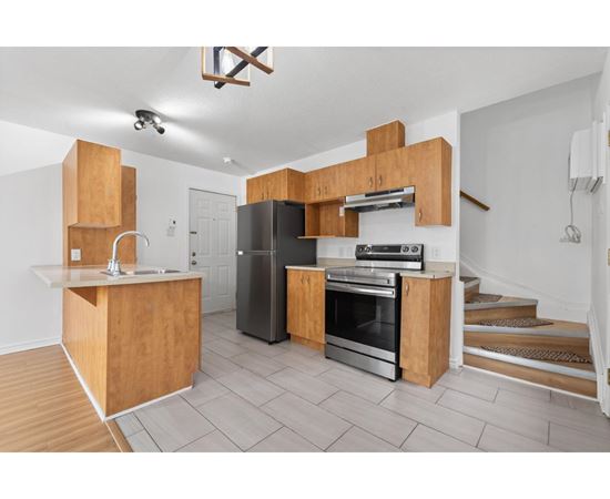 A kitchen with wooden cabinets and stainless steel appliances.