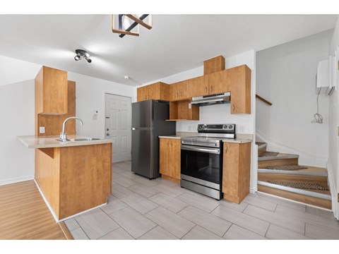 A kitchen with wooden cabinets and stainless steel appliances.