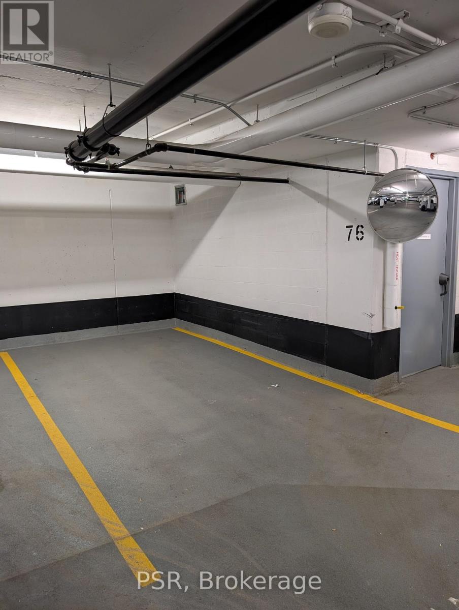 A parking garage with the number 76 on the wall.