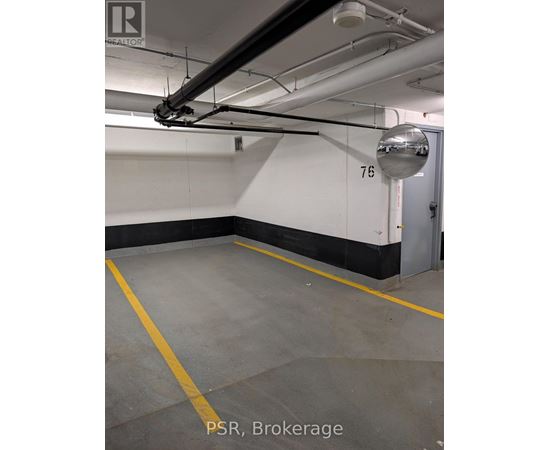 A parking garage with the number 76 on the wall.