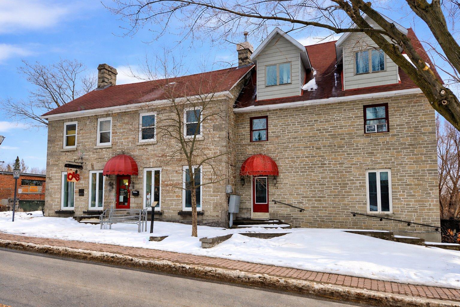 A house with a red awning and a red door.