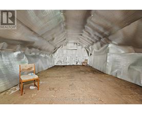 A room with a chair and a table in it.
