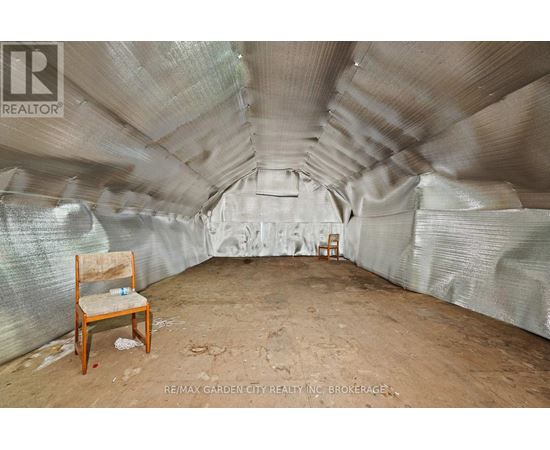 A room with a chair and a table in it.