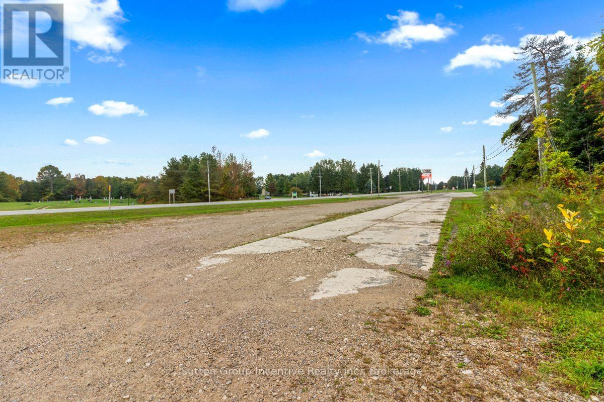 A road with a sign that says REALTOR in the distance.