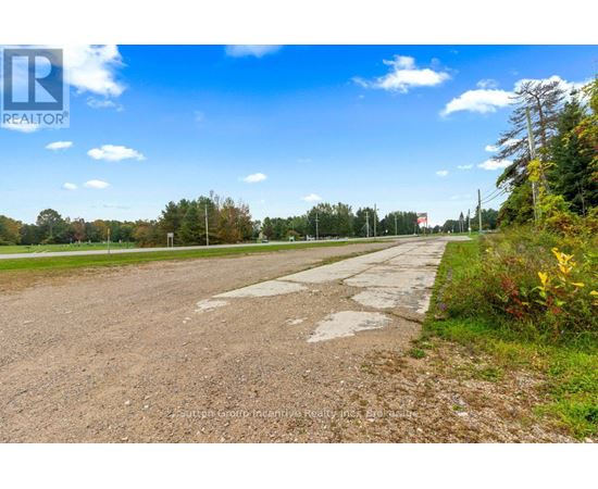 A road with a sign that says REALTOR in the distance.