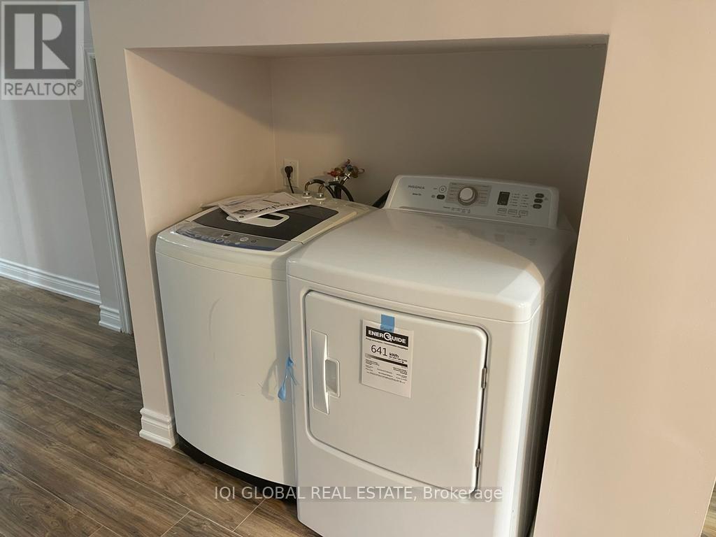A washer and dryer are in a small alcove.