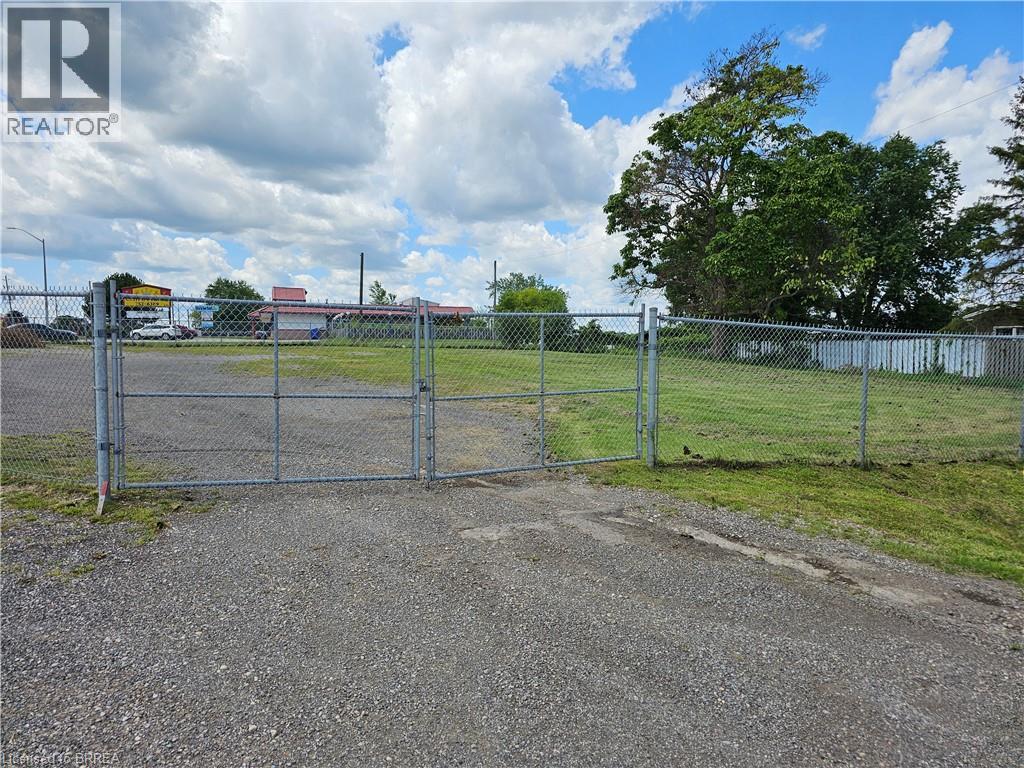 A gate leads to a fenced area with a sign that says REALTOR.