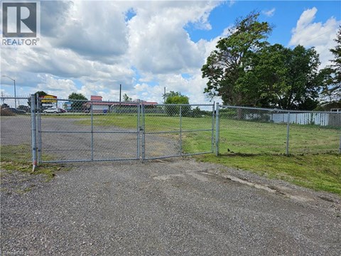 A gate leads to a fenced area with a sign that says REALTOR.