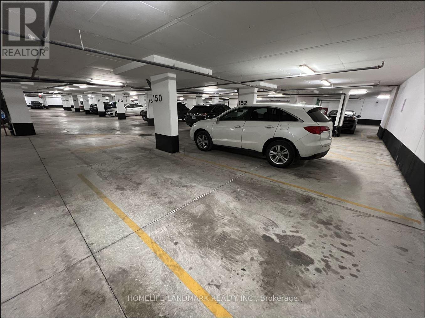 A white car is parked in a parking garage.