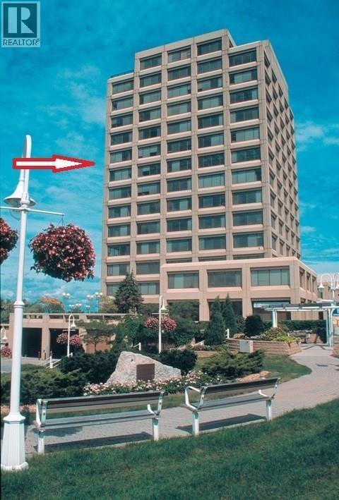 A tall building with a red arrow pointing to the left.